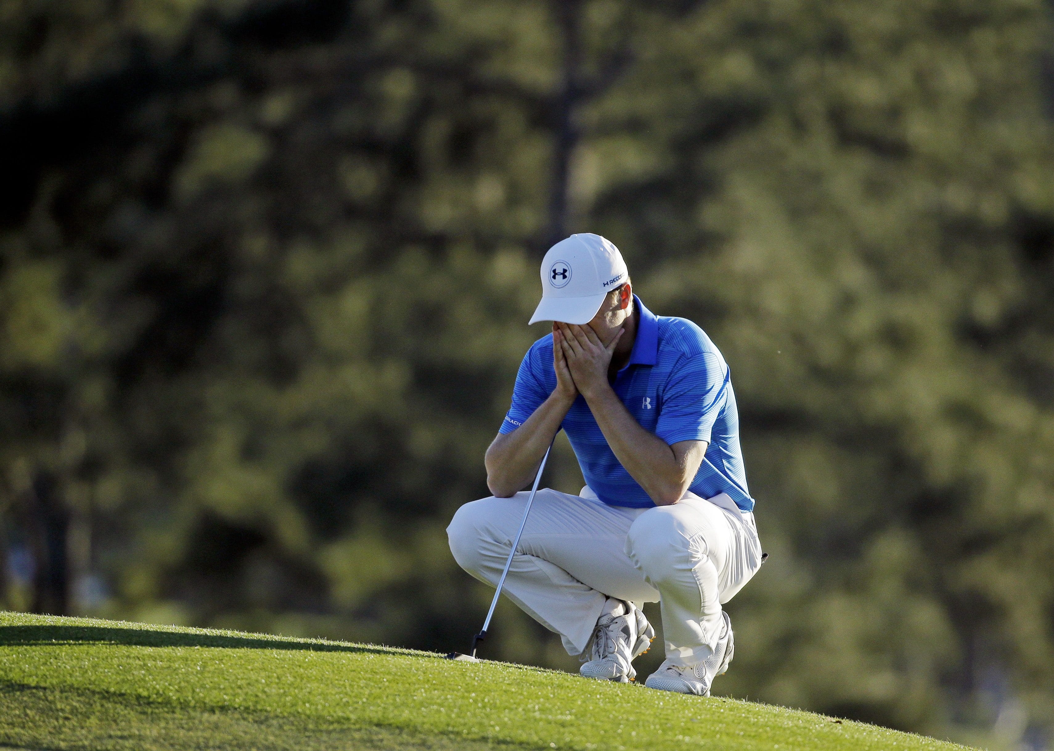 Jordan Spieth pauses on the 18th green before putting out during the final round of the Masters golf tournament Sunday, April 10, 2016, in Augusta, Ga.