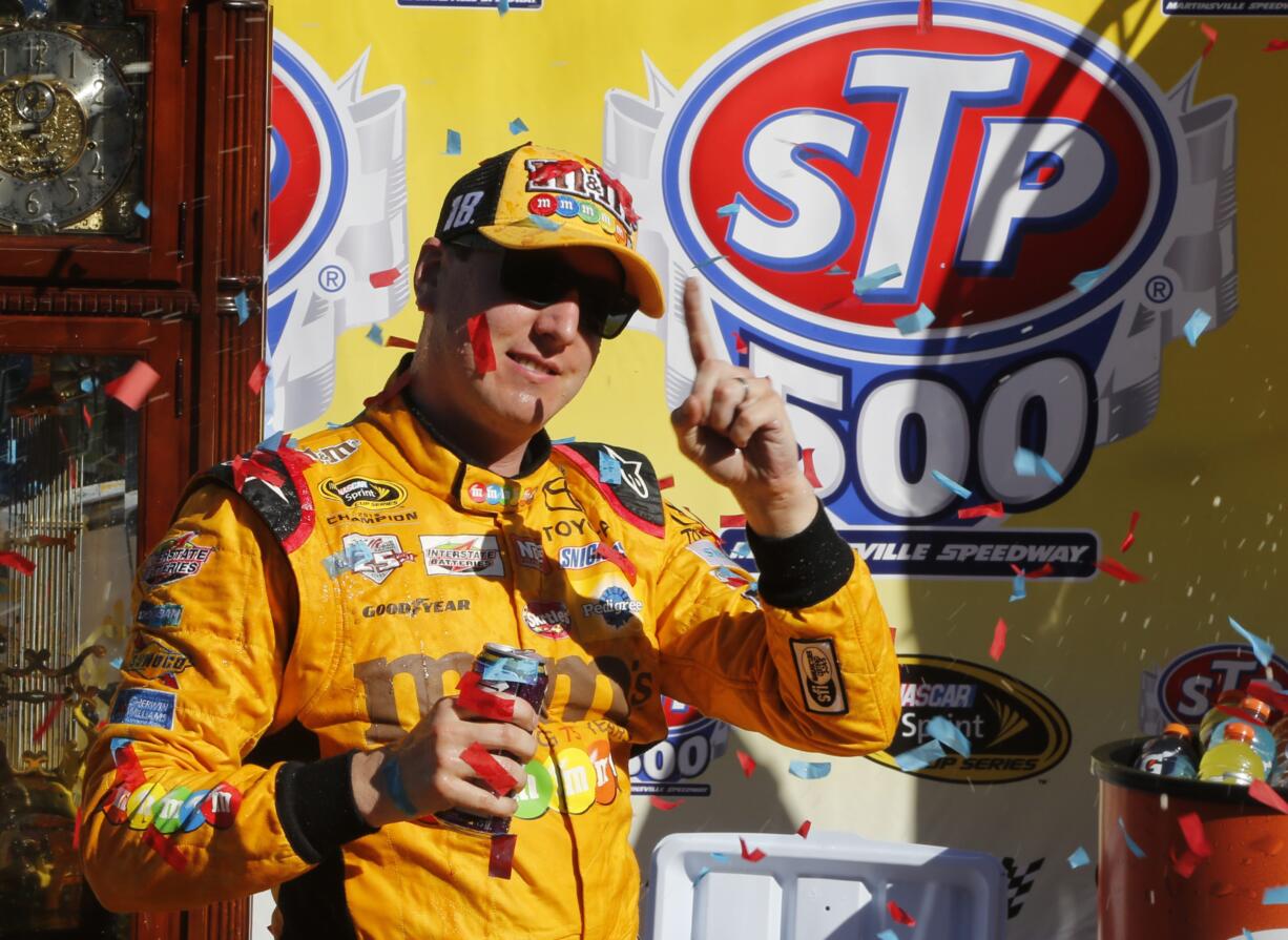 Kyle Busch celebrates winning the Sprint Cup auto race at Martinsville Speedway on Sunday, April 3, 2016, in Martinsville, Va.