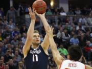 Gonzaga forward Domantas Sabonis shoots over Utah forward Chris Reyes during the first half of a second-round men's college basketball game Saturday, March 19, 2016, in the NCAA Tournament in Denver.