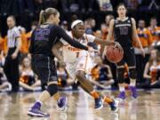 Syracuse's Alexis Peterson (1) is defended by Washington's Alexus Atchley (22) during the second half of a national semifinal game at the women's Final Four in the NCAA college basketball tournament Sunday, April 3, 2016, in Indianapolis. Syracuse won 80-59.