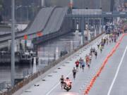 Lead elite runners in a 10K race held to kick off weekend ceremonies for the grand opening of the new State Route 520 floating bridge run in the eastbound lanes of the span across Lake Washington, Saturday, April 2, 2016 in Seattle. The structure will open to vehicular traffic later in the month. (AP Photo/Ted S.