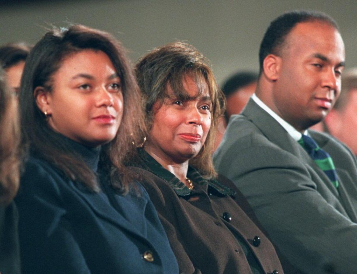 Alma Brown, center, flanked by daughter Tracey and son Michael, attends an April 9, 1996, memorial service in honor of her husband, Commerce Secretary Ron Brown, at the Metropolitan Baptist Church in Washington. Alma Brown, the widow of Ron Brown, who served as Commerce secretary under President Bill Clinton, has died, a family friend said. She was 76.