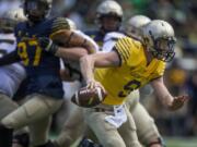 Quarterback Dakota Prukop scrambles during the Oregon Spring Game in Eugene, Ore., Saturday.