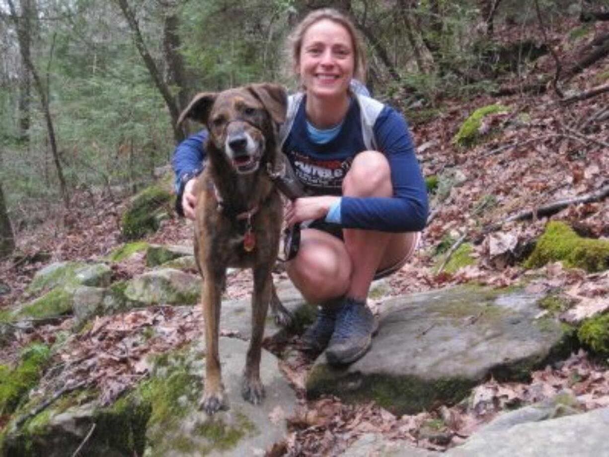 This 2011 photo provided by Amanda Tichacek shows Tichacek, of Skokie, Ill., and her sidekick, Roxie, a greyhound mix, on a trail in Signal Mountain, Tenn. Tichacek took up running -- then trail running -- with Roxie eight years ago. &quot;We have grown together as runners,&quot; says Tichacek. (Courtesy of Todd M.