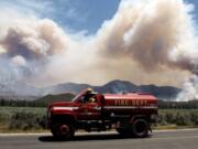 A water tender makes his way back to the 2013 Mountain Fire near Lake Hemet, Calif. Vast wildfires have created lengthy gaps in Southern California sections of the famed Pacific Crest Trail, leaving hikers to bypass via shuttles or choose alternate routes to avoid dangerous conditions such as unstable trees and loose rocks.