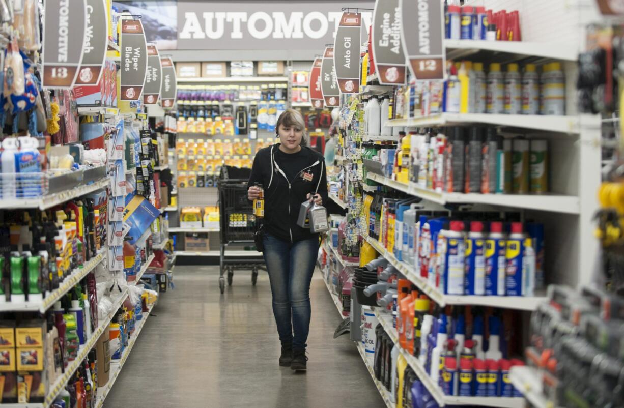 Parkrose Hardware employee Sarah Osilla stocks shelves in the automotive section in Vancouver in March.