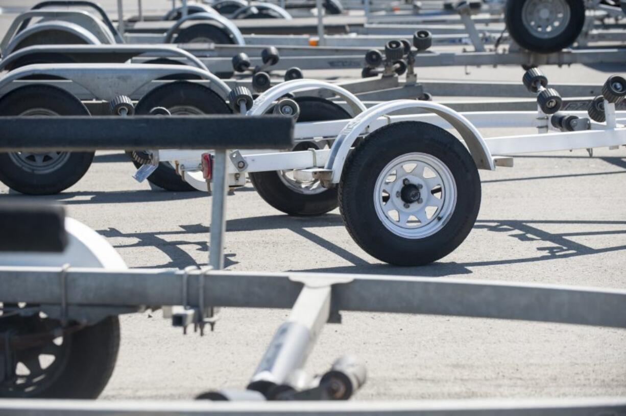 Dozens of trucks and boat trailers are parked at the Ridgefield boat launch on a warm April day, when back-ups at the launch leave people waiting to head out or return from trips.