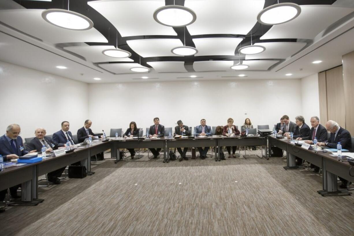 Syrian chief negotiator Bashar al-Jaafari, left, Ambassador of the Permanent Representative Mission of Syria to the UN and UN Special Envoy for Syria Staffan de Mistura, right, attend a round of negotiations between the Syrian government and the United Nations in Geneva, Switzerland, on Monday.