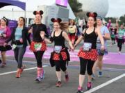 Costumed runners participate in a race at Walt Disney World in Lake Buena Vista, Fla. Many runners dress up for the popular half-marathons at Disney, where photo ops with costumed characters are as important as race times.