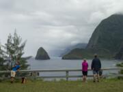 Hikers overlook a bluff on the Kalaupapa Peninsula in Kalawao, Hawaii. A visit to the island of Molokai offers a window on a unique and tragic chapter of Hawaiian history.