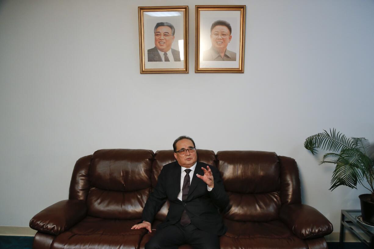 Seated under portraits of former North Korean Leaders Kim Il Sung, left, and Kim Jong Il, North Korea's Foreign Minister Ri Su Yong answers questions during an interview, Saturday, April 23, 2016, at the country's Permanent Mission to the United Nations in New York.