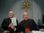 Cardinals Lorenzo Baldisseri, left, and Christoph Schoenborn show a copy of the post-synodal apostolic exhortation &quot;Amoris Laetitia&quot; (&quot;The Joy of Love&quot;) Friday during a press conference at the Vatican. Pope Francis has insisted that individual conscience be the guiding principle for Catholics negotiating the complexities of sex, marriage and family life in a major document released Friday that repudiates the centrality of black and white rules for the faithful. In the 256-page document &quot;The Joy of Love,&quot; Francis makes no change in church doctrine.