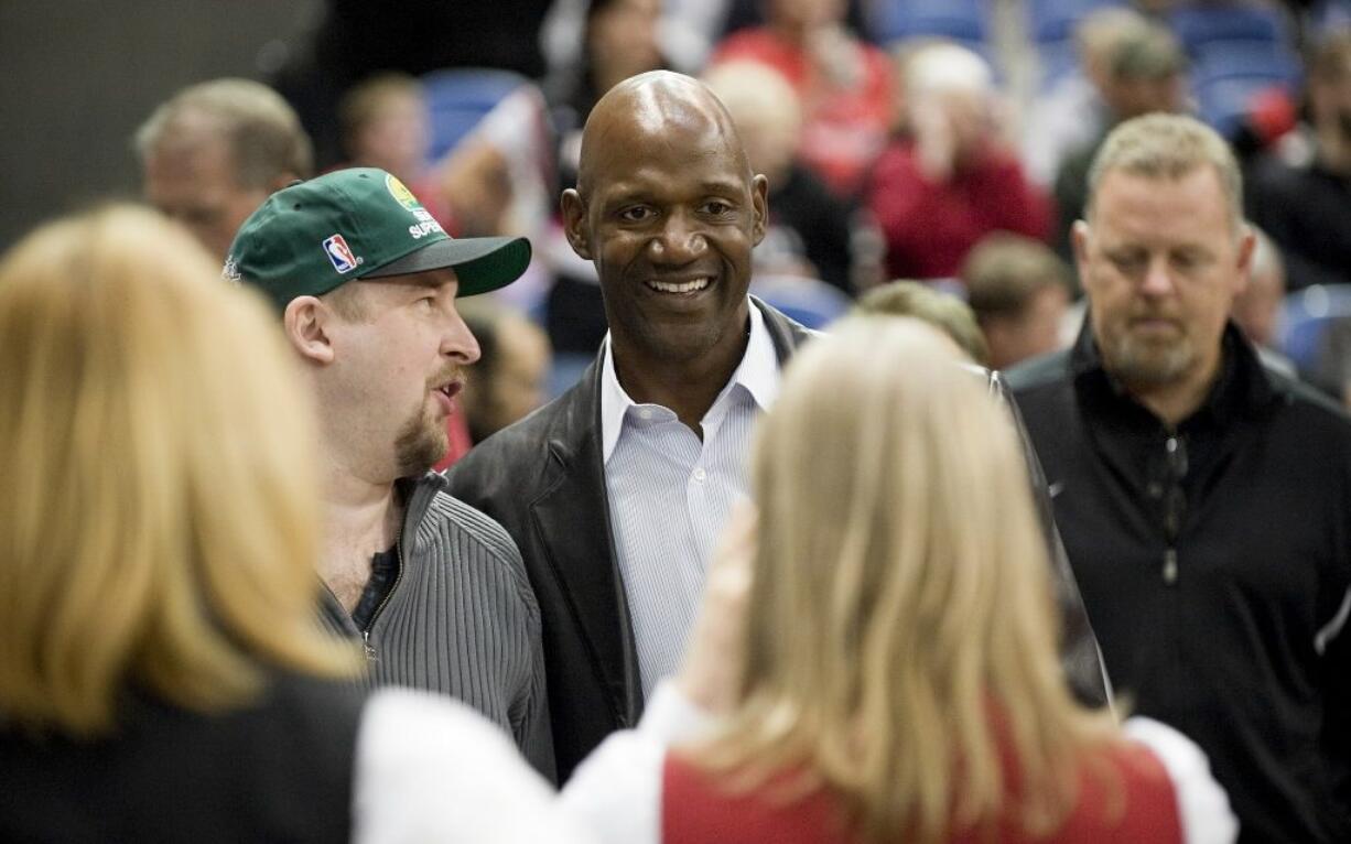 Terry Porter, center, has been named head coach of the University of Portland men's basketball team.