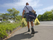 Letter carrier Jeff Lovell picks up food donations along his route in Vancouver during last year&#039;s National Association of Letter Carriers&#039; Food Drive. The drive is always held on the second Saturday in May.