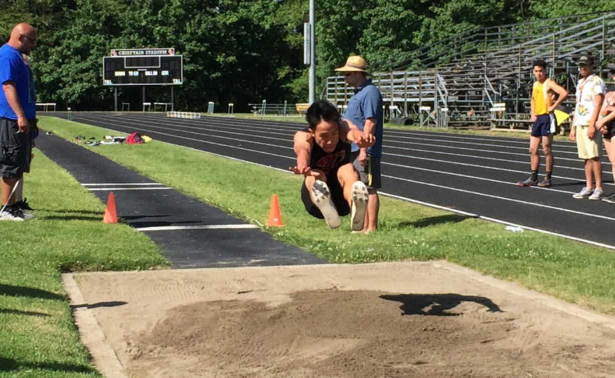 Prairie senior David Tran leaps 21 feet, 9 inches to win the long jump at the Class 3A Greater St. Helens League track and field meet Thursday at Columbia River High School.