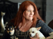 Laura Gordon, with two of her own dogs, Luke, left, and Nicki Sixx, at home in Madera, Calif., on Friday, April 22, 2016. Gordon writes dog bios for Labrador Retriever Rescue of Fresno from the viewpoints of the dogs.