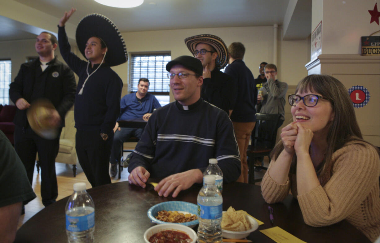 Dawn Eden Goldstein sits with her team during their Wild Wild West Trivia Night at University of St. Mary of the Lake on April 23 in Mundelein, Ill. Goldstein will be the first woman at the university earn a sacred theology doctorate.