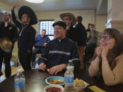 Dawn Eden Goldstein sits with her team during their Wild Wild West Trivia Night at University of St. Mary of the Lake on April 23 in Mundelein, Ill. Goldstein will be the first woman at the university earn a sacred theology doctorate.