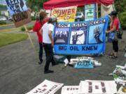 Opponents of the proposed Millennium Bulk Terminals in Longview prepare signs for display at the Cowlitz County Convention Center on Tuesday morning.