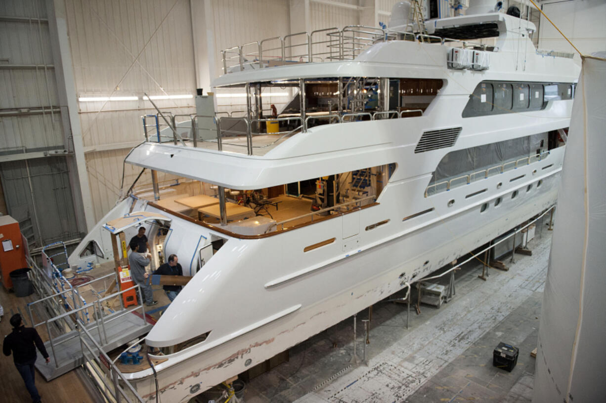 Employees of Christensen Shipyards work aboard a luxury yacht under construction in January in Vancouver.