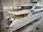 Employees of Christensen Shipyards work aboard a luxury yacht under construction in January in Vancouver.