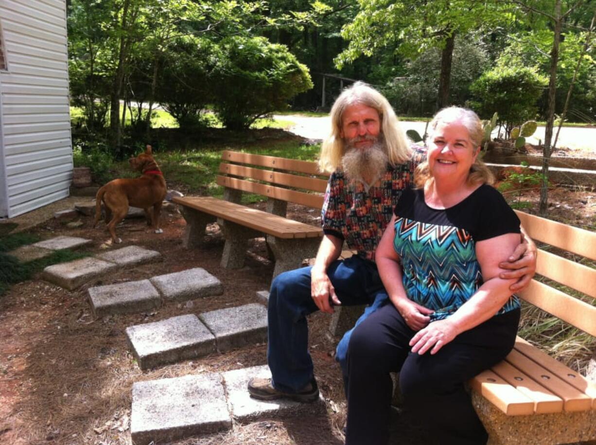 Don and Cindy Bradley, caretakers at the Palestine Gardens, pose for a portrait on April 22 in Lucedale, Miss.