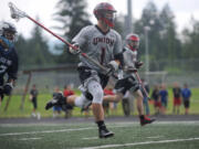 Union&#039;s Hunter Cofer sprints with the ball as he plays in a state semifinal lacrosse match against Gonzaga Prep in Camas High School&#039;s Cardon Field Wednesday May 25, 2016.