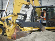 Alex Dostal, 12, a fifth-grader at Sifton Elementary School, runs an excavator in 2015 with help from Rob Richardson of Nutter Corp. at the Clark County Event Center at the Fairgrounds.