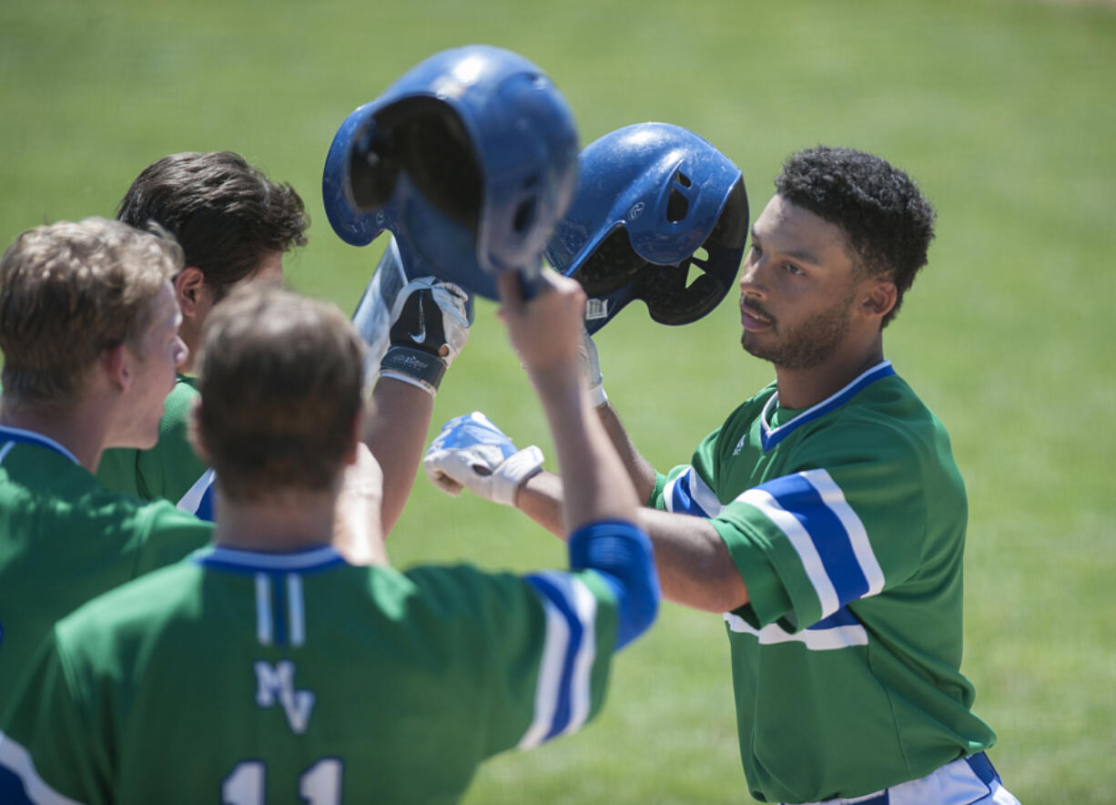 Mountain View&#039;s Preston Jones, right, celebrates with teammates after hitting a home run in the first inning Saturday afternoon, May 7, 2016 at Propstra Stadium.