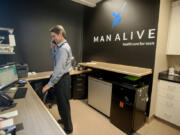 Dave McQuivey helps a caller on the phone Wednesday afternoon at Man Alive Clinic.