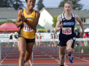 Hudson's Bay's Erykah Weems, left, celebrates as she crosses the finish line in 1st place during the 2A Girls 100 Meter Hurdles event at the State Track and Field Championships on May 27, 2016, in Tacoma, Wash.  Hockinson's Alyssa Chapin is on the right.