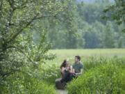 Anna and Ronald Curtman take in nature at the Steigerwald Lake National Refuge. An $18 million project calls for making the refuge more inviting for both humans and wildlife.