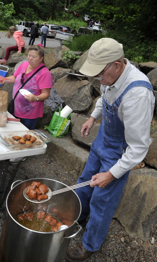 Kurt Friedmann makes fry bread from wheat flour ground at the Cedar Creek Grist Mill. Friedmann said he has volunteered at the mill for about 10 to 12 years, and said some kids were eager to learn how to make bread while others just wanted a snack.