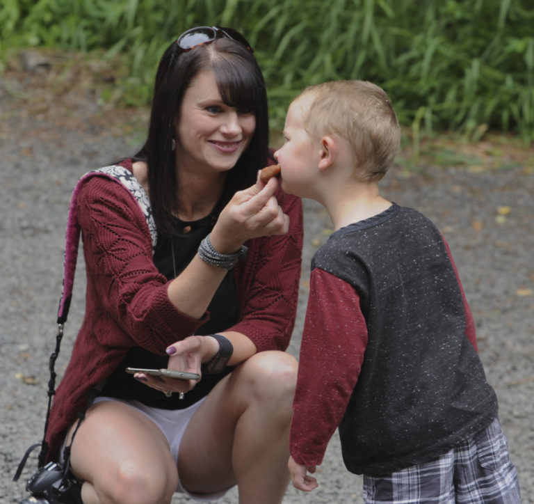 Aaron Fulbright, 3, gets his first taste of  fry bread from his mother, Angela Fulbright, at the Cedar Creek Grist Mill&#039;s Bread and Butter Day. The cinnamon sugar-covered treat was Aaron&#039;s favorite part of the day.