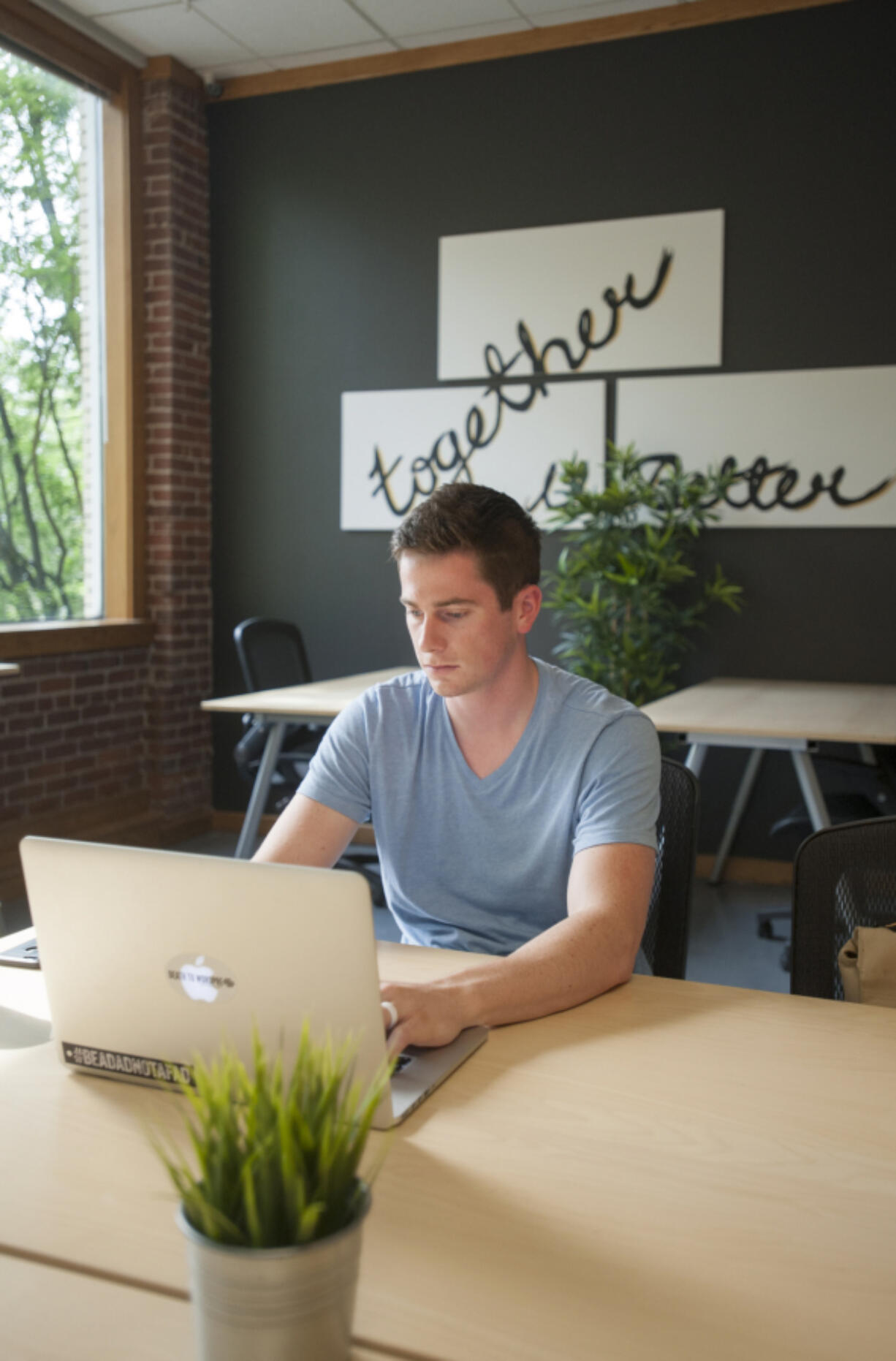 Web designer Kylan Johnson works May 3 at the new Columbia Collective in downtown Vancouver. The co-working space brings freelancers and small companies together under one roof. &quot;As a local Web designer, it&#039;s nice to be around other people in the creative industry,&quot; Johnson said.