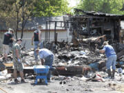 Volunteers rally to help Lisa Berck, whose home was destroyed in a fire May 1, clean up the remains and help her avoid a big fine.