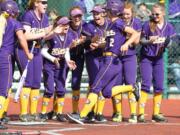 Columbia River&#039;s  Izzy Parker (2) is met at home plate after hitting a two-run homer against Eastside Catholic during the 2016 3A State Championships May 27, 2016 at Regional Athletic Complex in lacy Washington. The Chieftains beat the Crusaders 10-7.