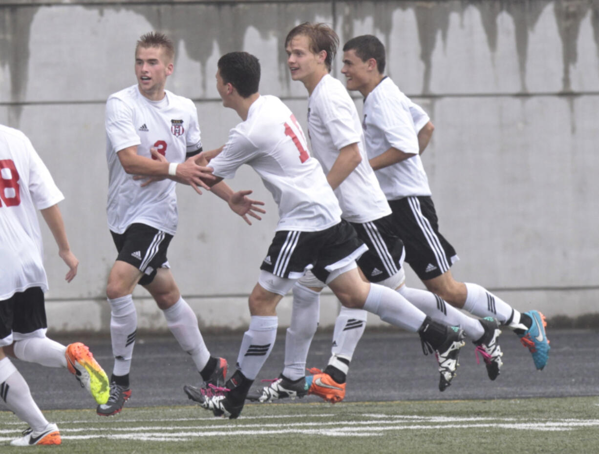 Camas forward Bennett Lehner (L) celebrates goal with teammates vs. Woodinville in 4A bi-district boys soccer match.