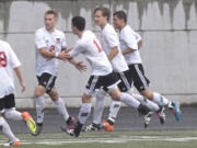 Camas forward Bennett Lehner (L) celebrates goal with teammates vs. Woodinville in 4A bi-district boys soccer match.