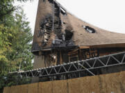 Damaged sections of the First Congregational United Church of Christ were boarded up Sunday morning. The building was damaged in a suspected arson Wednesday.