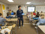 View Ridge Middle School math teacher Nam Nguyen works with eighth-grade students in a crowded portable classroom at View Ridge Middle School. Ridgefield School District&#039;s board recently approved adding 11 modular classrooms to the district next year to help with growing population.