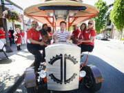 Mayor Tim Leavitt sits in the driver&#039;s seat of the Couve Cycle, a pedal-powered party cycle, during the Greater Vancouver Chamber of Commerce&#039;s Small Business Crawl in Uptown Village on Wednesday. Owner Michael Palensky sits on the left in the second seat from the front.