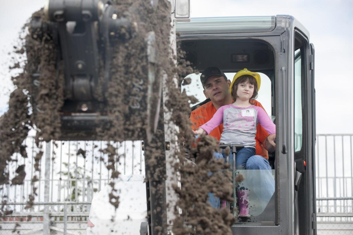 Burton Elementary school student Ashley Keniston 5, gets a turn to operate an earth moving machine at the preview day for Dozer Days at the Clark County Fairgrounds in Ridgefield Friday May 20, 2016. Students from Evergreen public schools got a chance to participate in the Dozer Days Event.