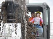 Burton Elementary school student Ashley Keniston 5, gets a turn to operate an earth moving machine at the preview day for Dozer Days at the Clark County Fairgrounds in Ridgefield Friday May 20, 2016. Students from Evergreen public schools got a chance to participate in the Dozer Days Event.