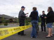 Deputy Fire Marshal Dan Young, left, briefs congregants of the Liberty Bible Church of the Nazarene in Salmon Creek on Thursday. The suspected arson was the second on a church in as many days.