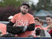 Volunteer Loren Egbert hauls away asphalt chunks removed Sunday from the parking lot of Everyday Deals in Vancouver&#039;s Rose Village neighborhood. Many volunteers from Summit View Church wore their “LOVE Vancouver” T-shirts, the name of a community service program at the church.