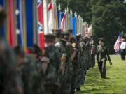 Emily Brinton, 16, of the Lewis &amp; Clark Young Marines walks past the flags of each state before the start of the Memorial Day service Monday morning at Fort Vancouver National Historic Site.