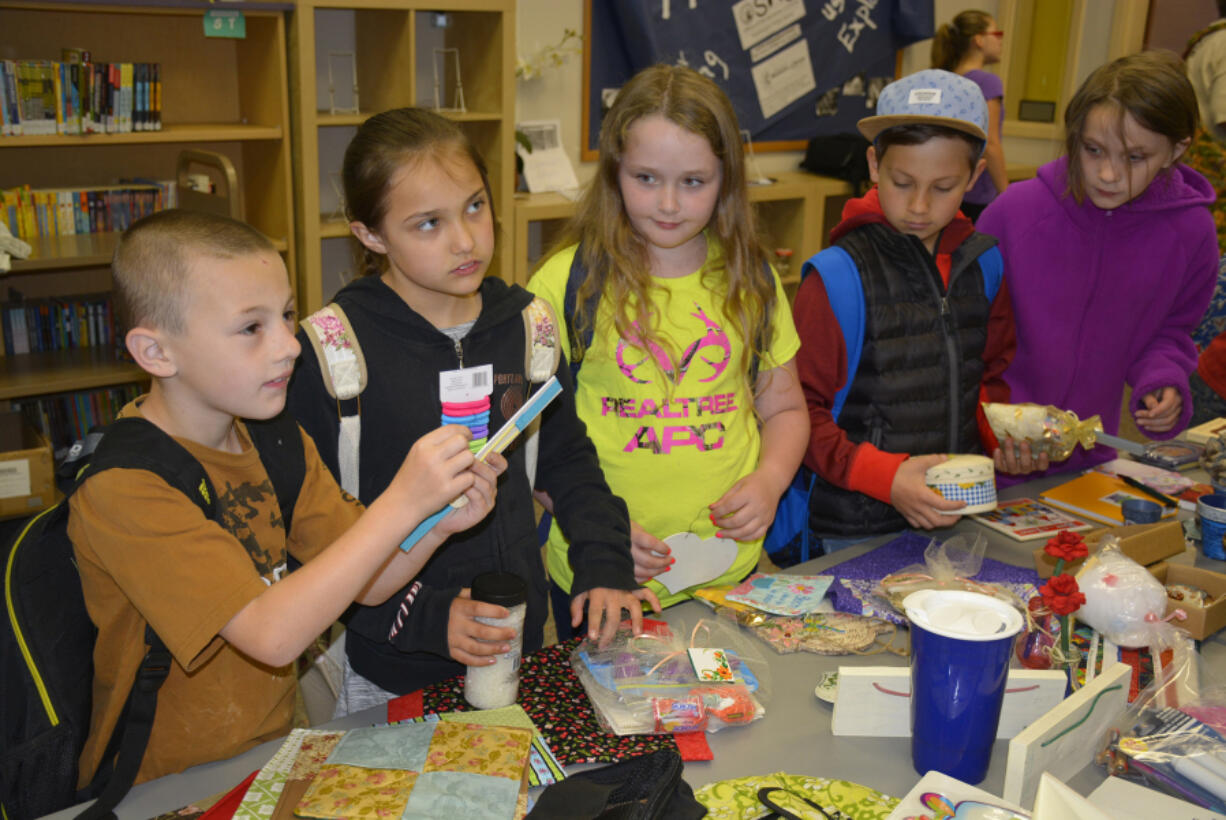 Washougal: Brayden Reeves, from left, Kaitlynn Dunn, Emily Bishop-Perry, Aaron Poljakov and Zoe Derico select gifts for Mother’s Day at Hathaway Elementary School.