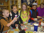 Washougal: Brayden Reeves, from left, Kaitlynn Dunn, Emily Bishop-Perry, Aaron Poljakov and Zoe Derico select gifts for Mother’s Day at Hathaway Elementary School.