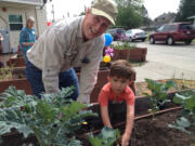 Landover-Sharmel: Mark Anderson and grandson Oliver Phelan work during Good Shepard Montessori School&#039;s plant sale.